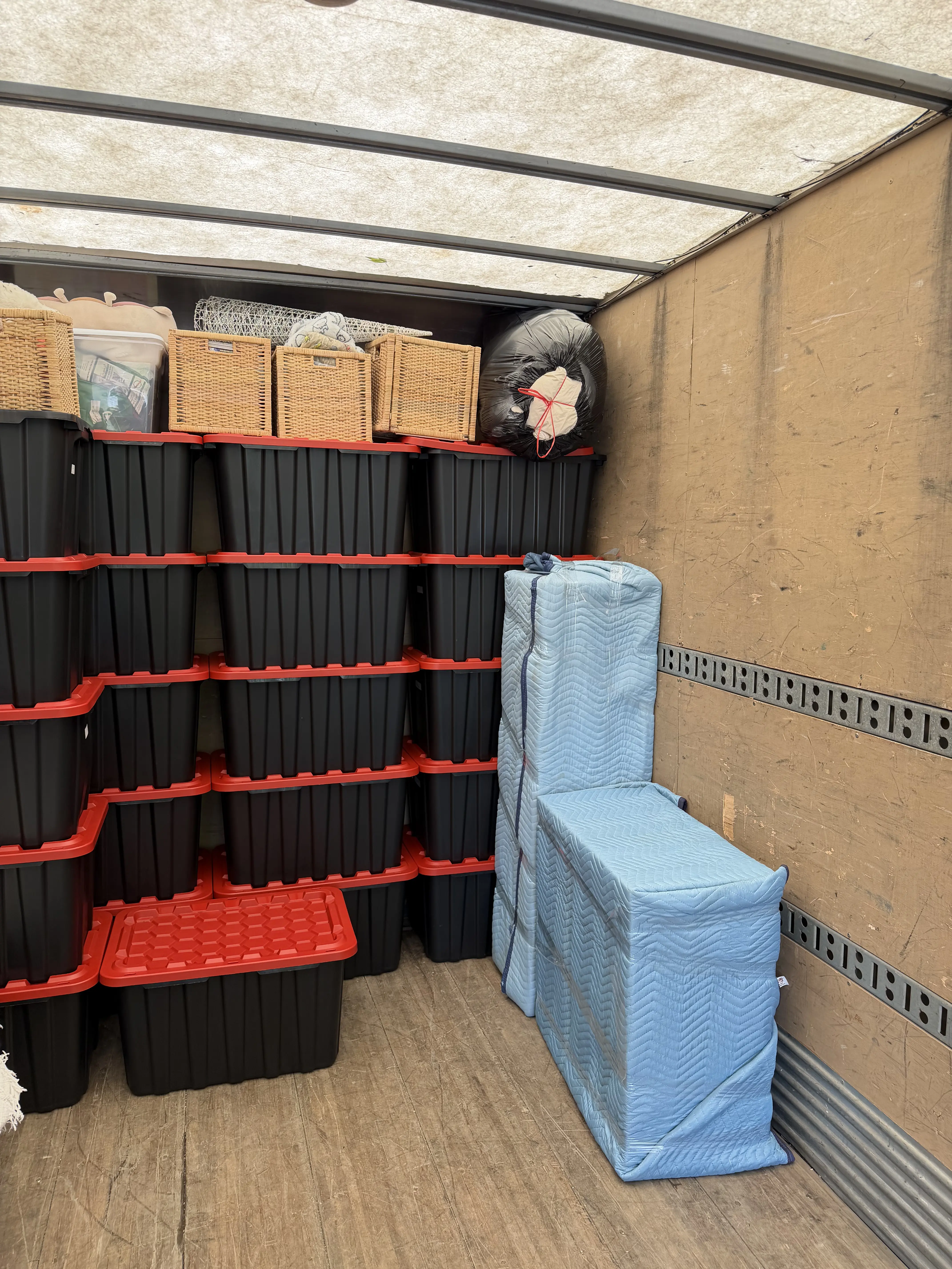 Movers handling heavy items with proper equipment